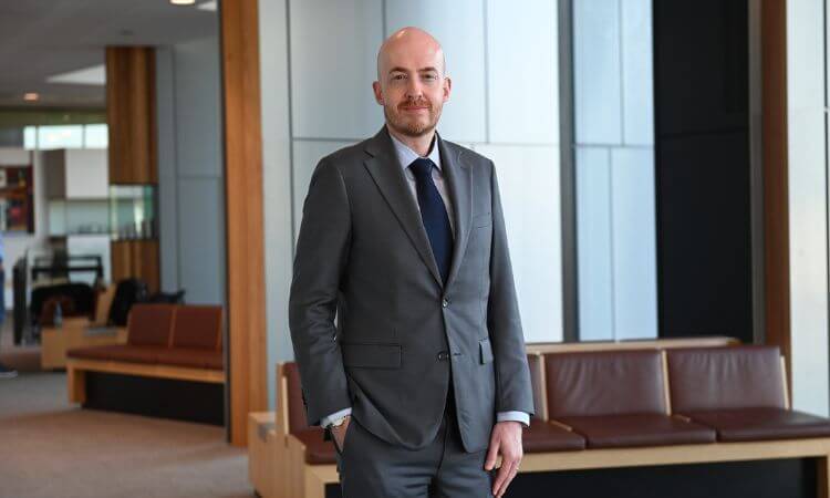 man in suit smiling at camera