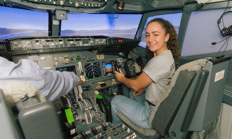 girl in cockpit of a flight simulator 