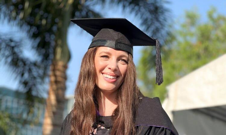 woman in graduation dress smiling 