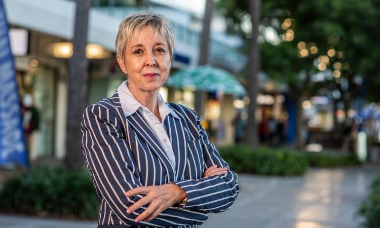 Professor Retha Wiesner stands with her arms crossed.