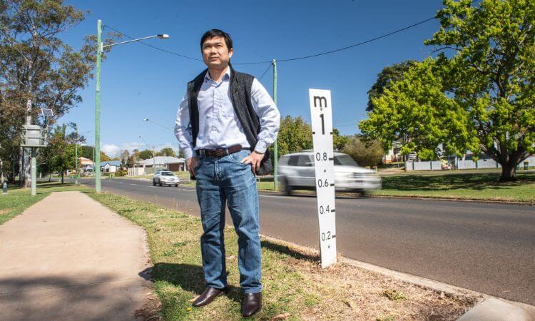 man standing on side of road