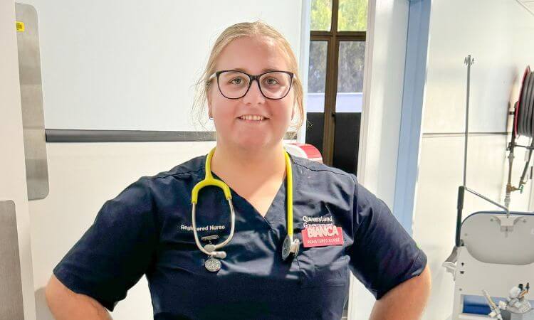 A nurse standing in a hospital room with a stethoscope.