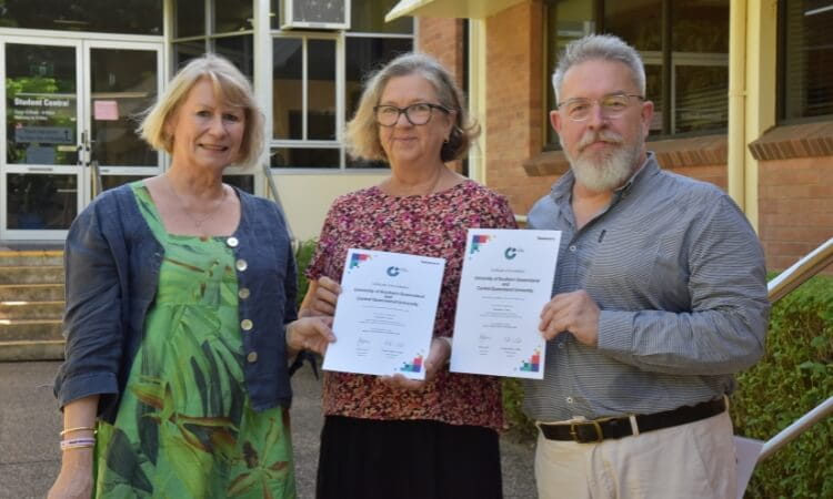 People holding certificates.