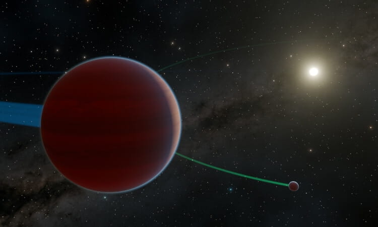 A large red planet and a smaller moon orbit a distant star, with faint orbital paths visible against a backdrop of stars and a galaxy.