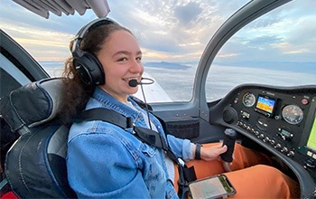 Nicole flying in a plane