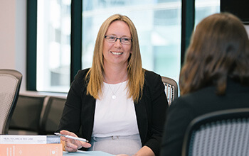 UniSQ Law graduate sitting in boardroom 