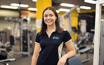 UniSQ student, Lucy, standing in a gym.