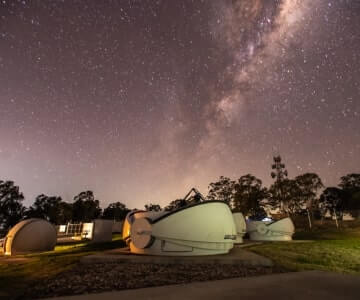 An observatory under a starry night sky.