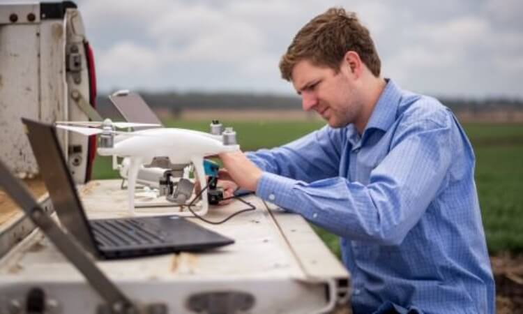 man with a drone in a paddock