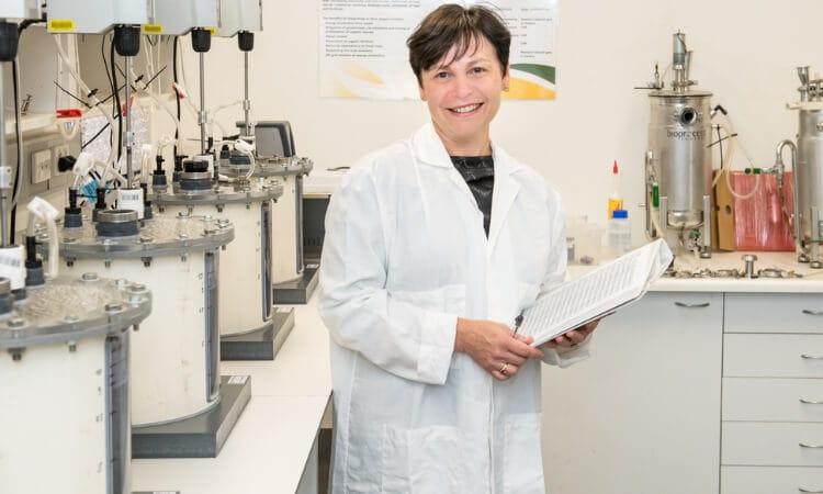 woman in a lab coat inside a labratory 