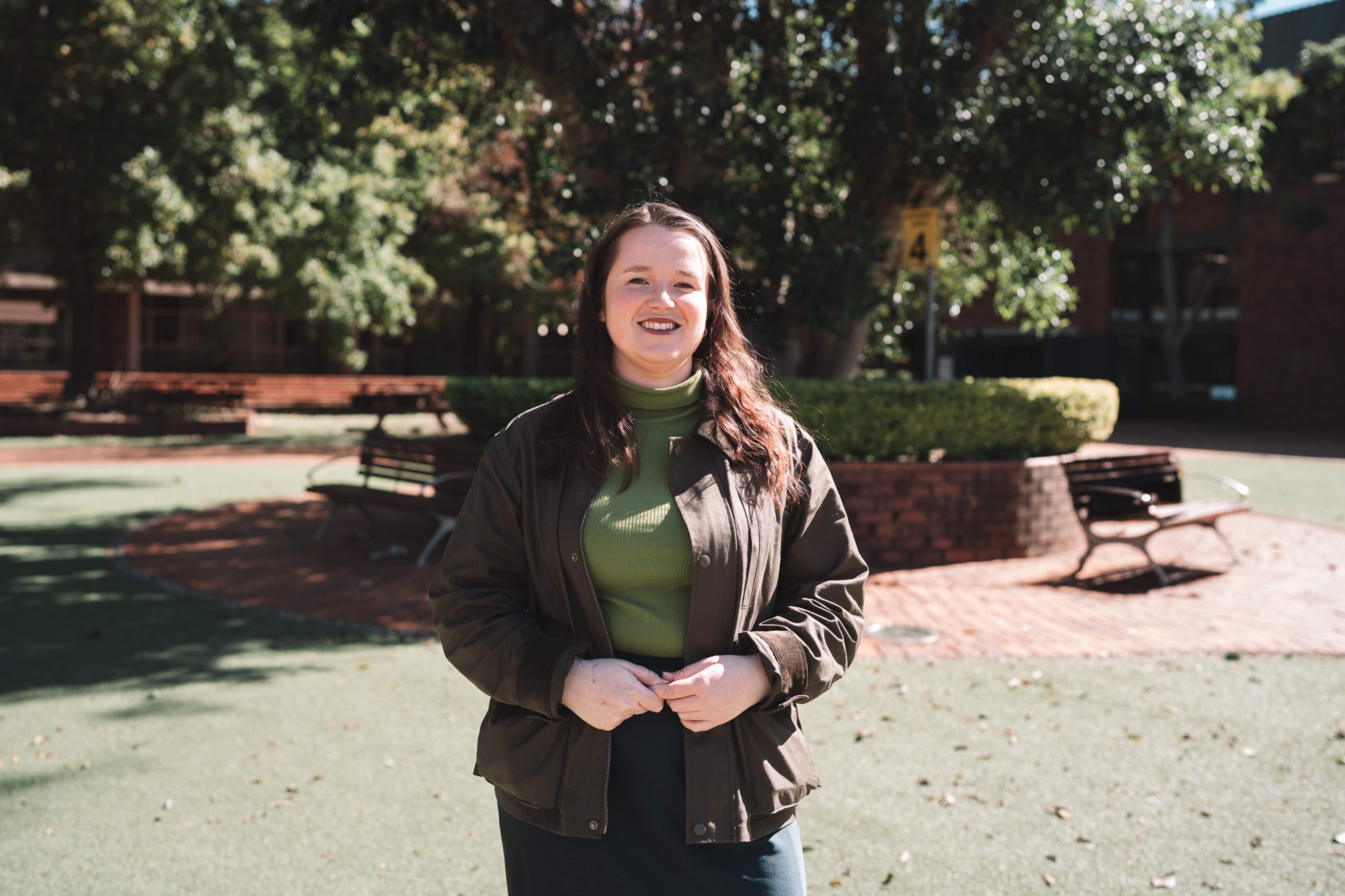 woman standing in courtyard visual of space behind her