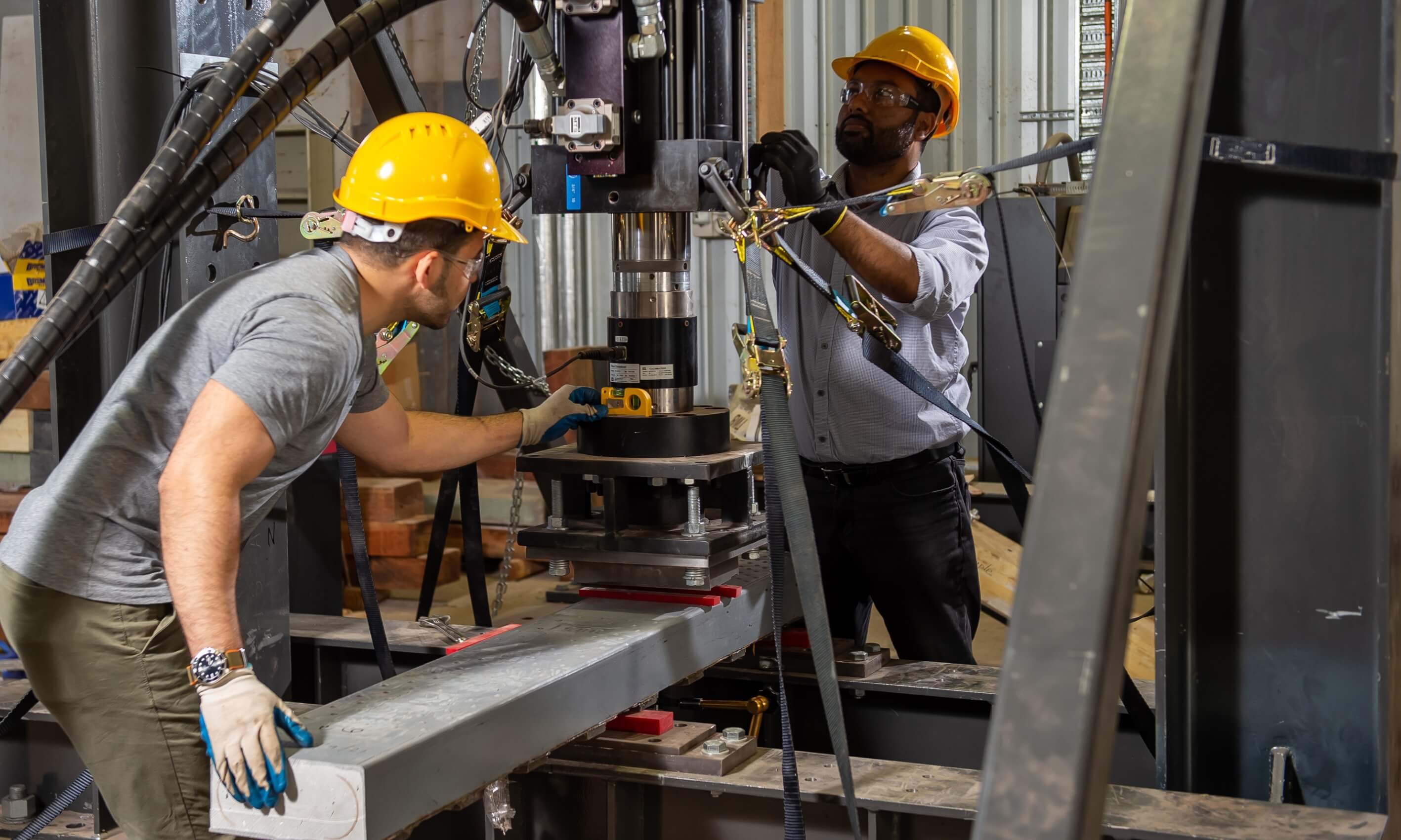 men working on a hydraulic machine
