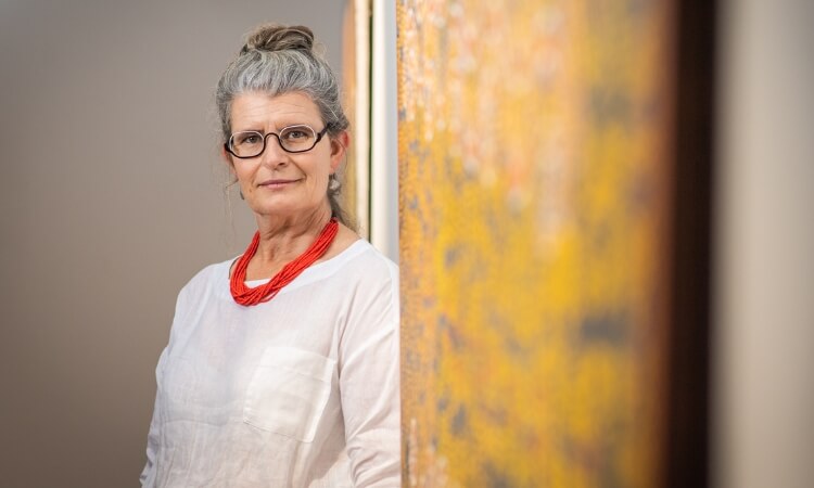 a professor looking placidly at the camera