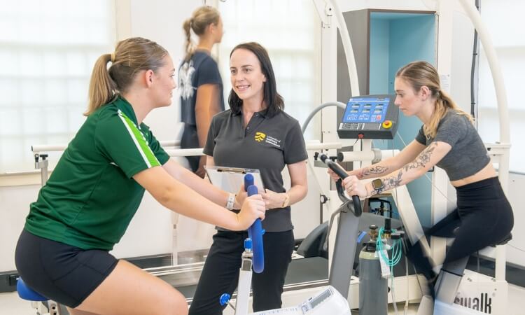 UniSQ woman coaching exercise in a gym