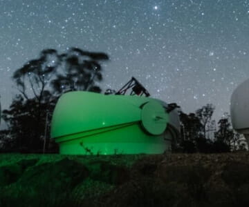 An observatory dome under a starry night sky.