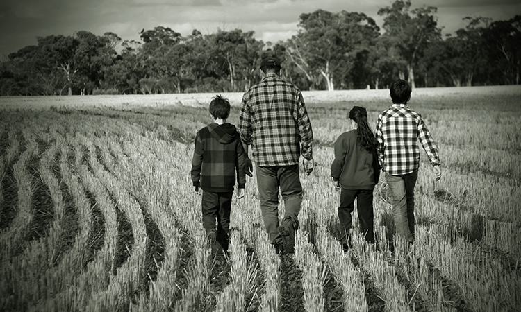 Farming family in paddock.