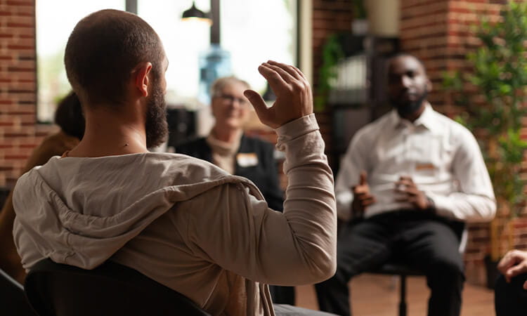 Two man talking in a counselling session.