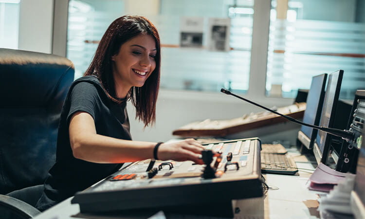 A lady using a soundboard. 