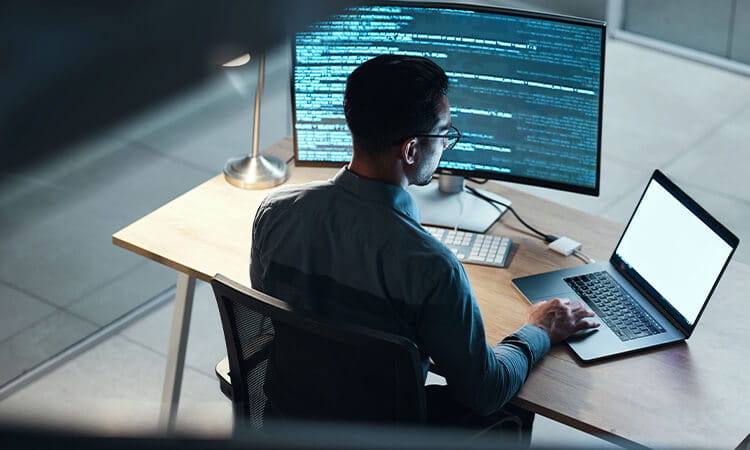 Man working on code at a computer.