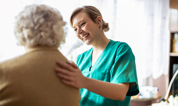 A nurse looking after an elderly lady.