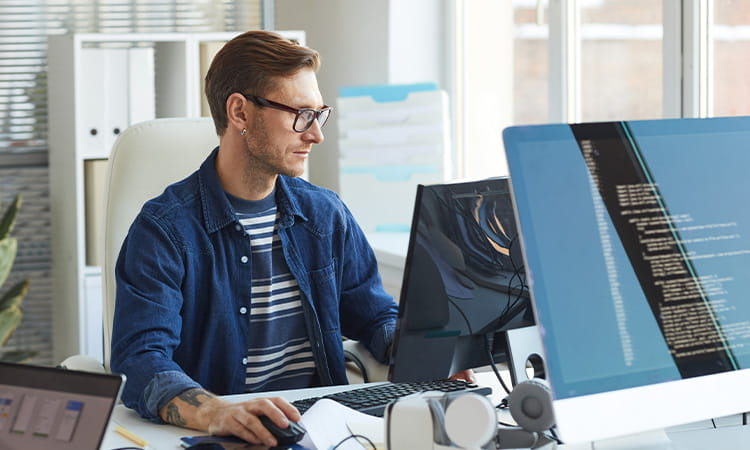 Web developer sitting at computer. 