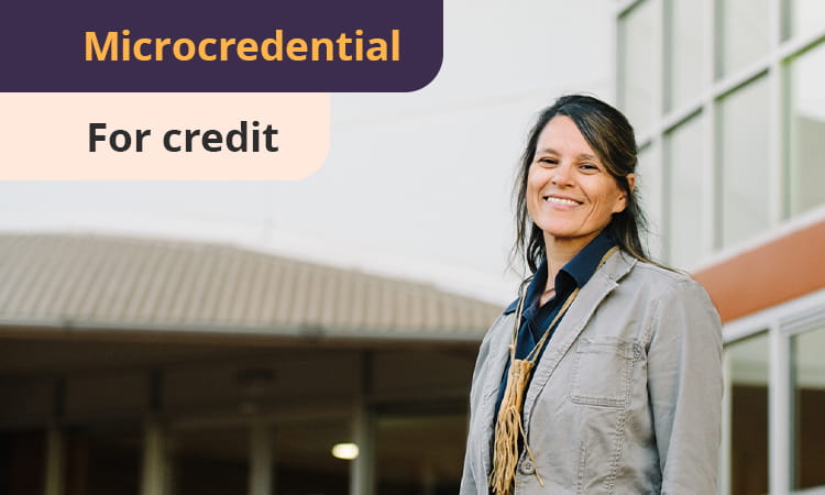 A woman in a gray jacket stands outside a building, smiling, with the word "Microcredential" displayed in a purple banner.