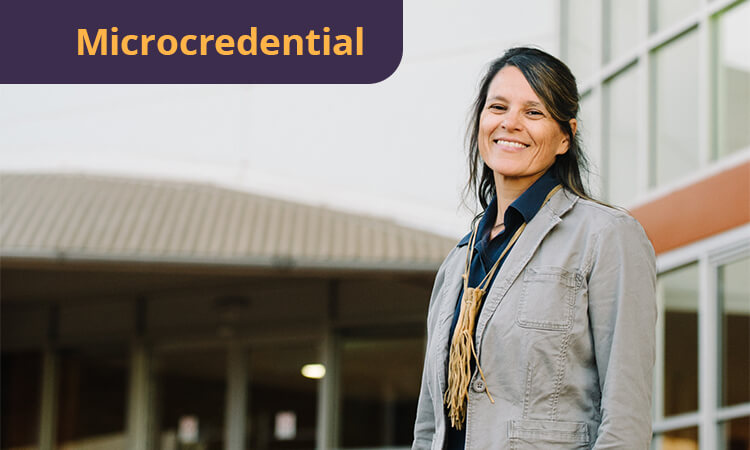 A woman in a gray jacket stands outside a building, smiling, with the word "Microcredential" displayed in a purple banner.