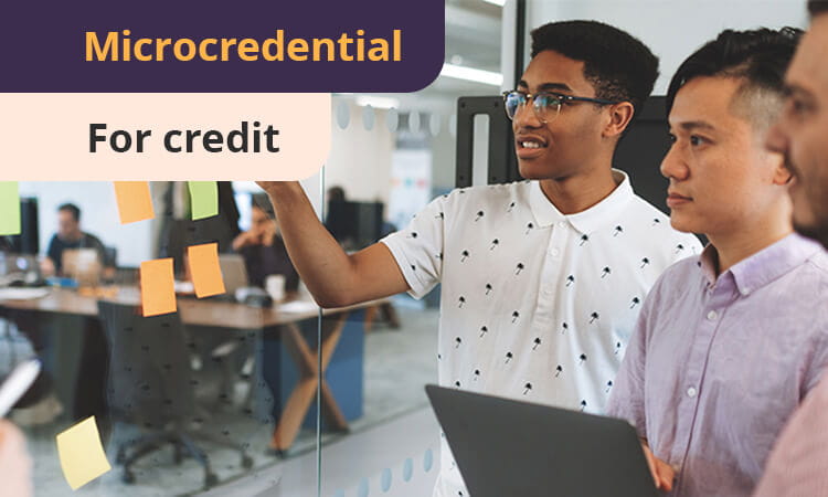 Three people collaborate in an office, discussing notes on a glass board. Text reads "Microcredential for credit.