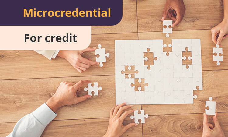 Four hands collaborate to complete a white jigsaw puzzle on a wooden table. Text reads: "Microcredential For credit.