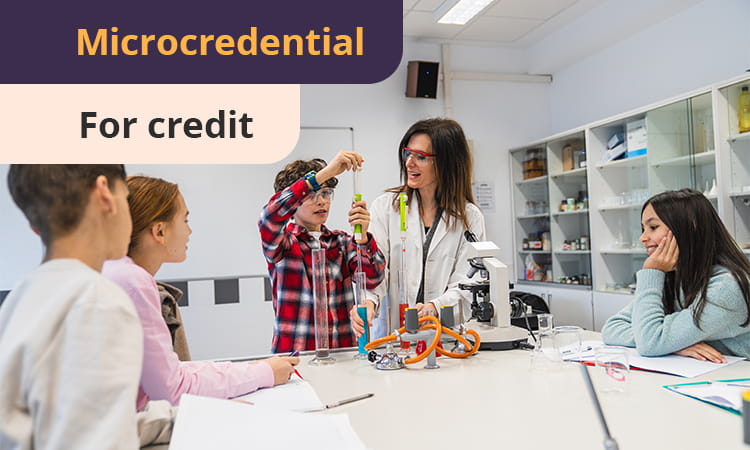 A teacher supervises students conducting a science experiment in a classroom. The word "Microcredential" appears at the top left of the image.