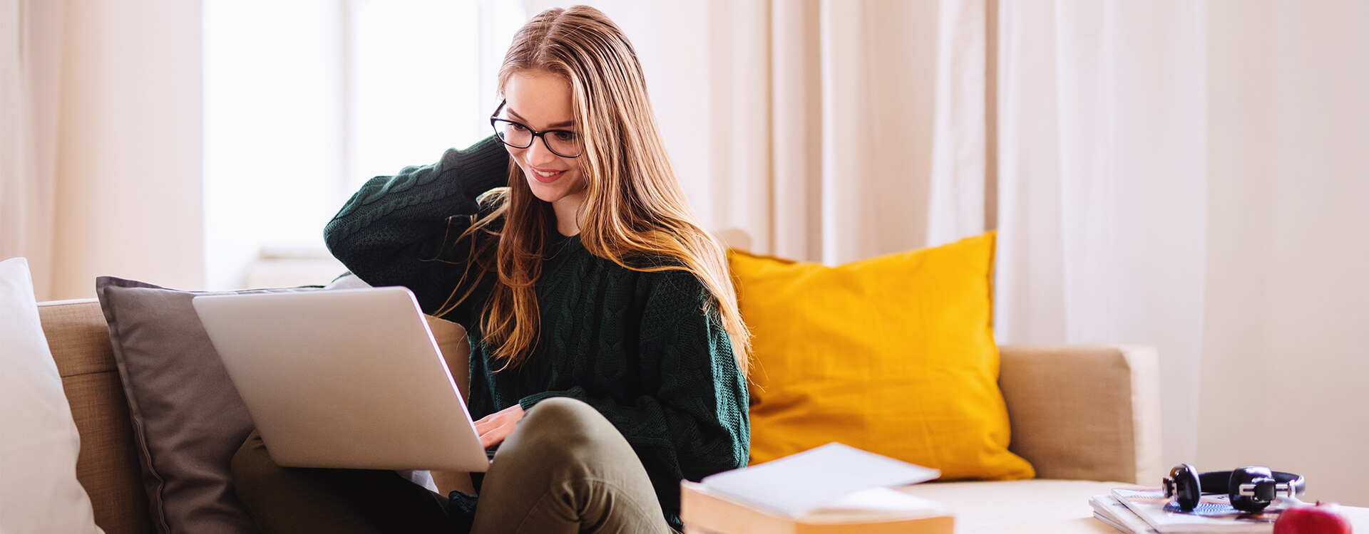 Female sitting on couch with laptop