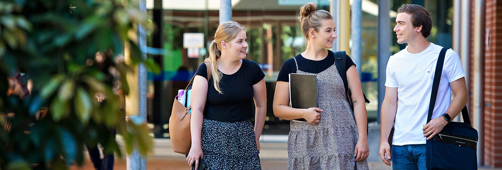 Three students walking on the UniSQ Ipswich campus.