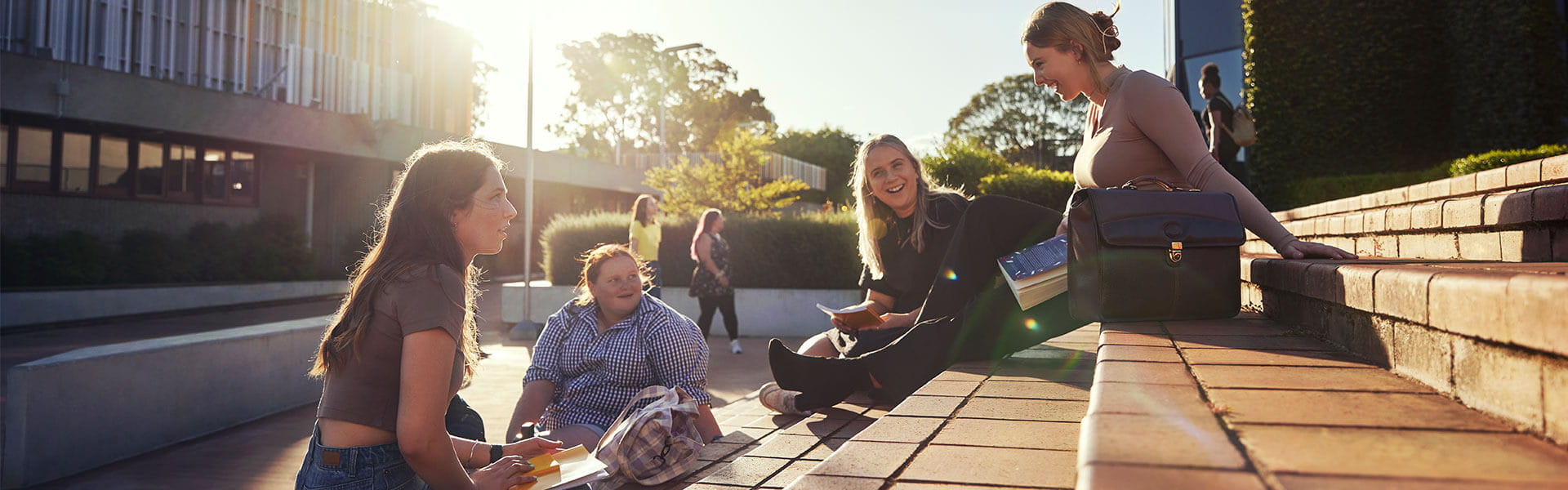 Group of students sitting on steps at the Toowoomba campus