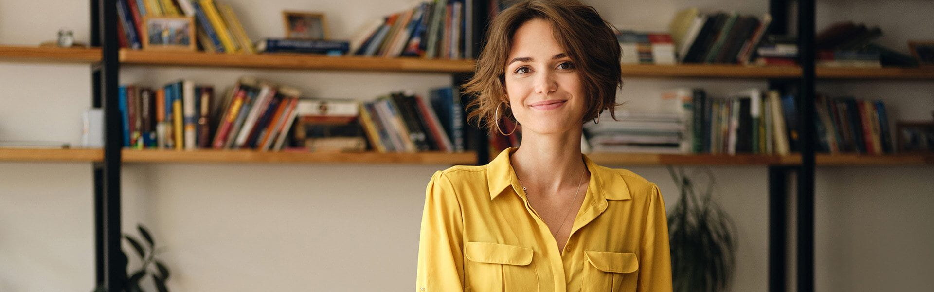 Student in office smiling at camera.