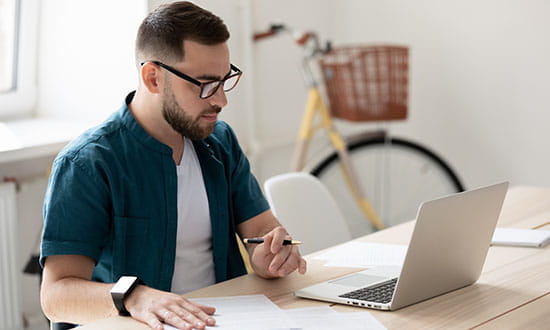 Male sitting at laptop.