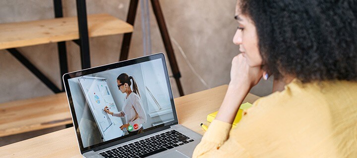 Student watching online lecture. 