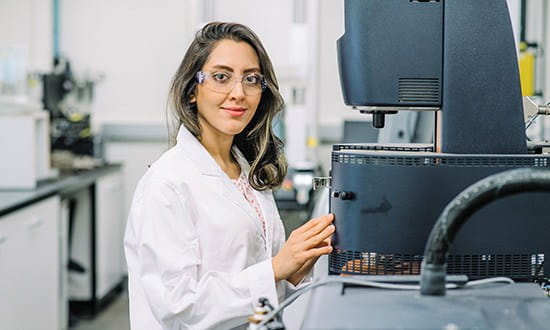 Research student in a lab using specialised equipment. 