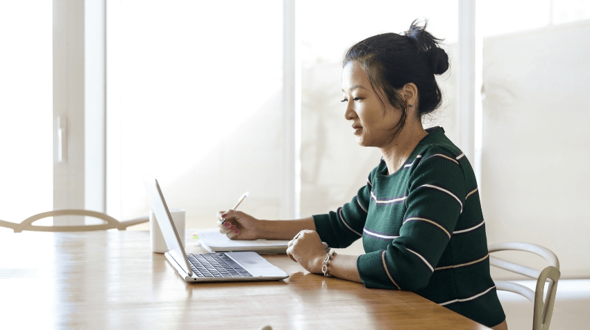 Woman studying at desk on laptop