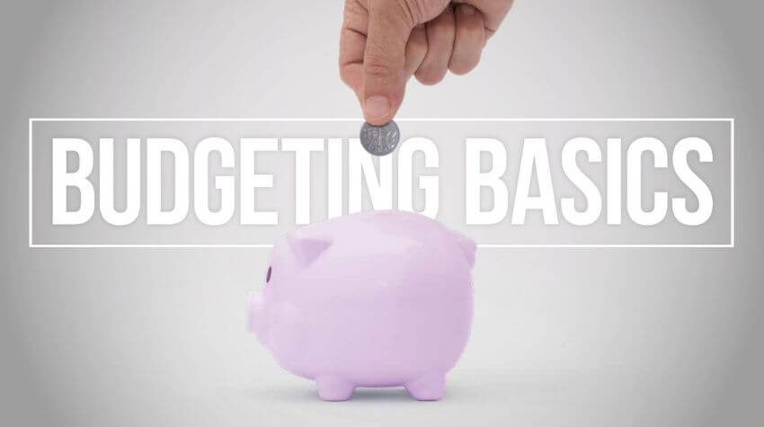 A hand inserting a coin into a pink piggy bank with the words "budgeting basics" displayed above.