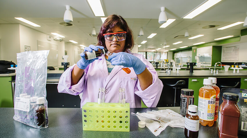 Woman at table with lab equipment