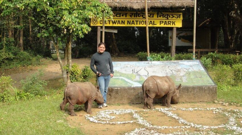 Ganesh smiling at the camera with Nepalese Rhinos.
