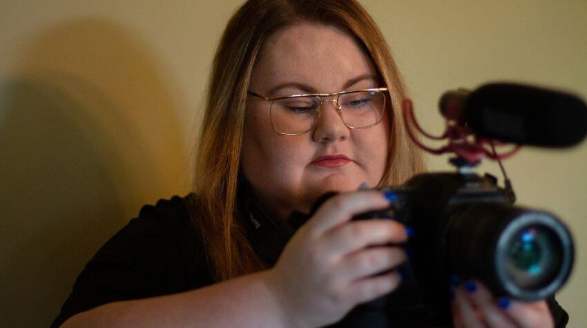 University film student looking through camera