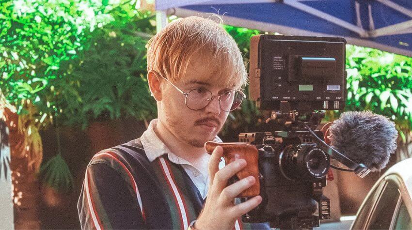 unisq graduate holding a camera