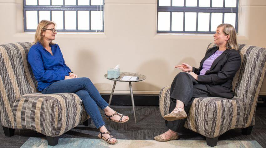 Nicole talking in a counselling session.