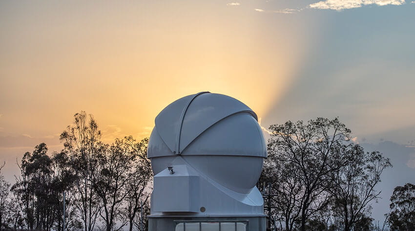 Telescope dome in front of sunset