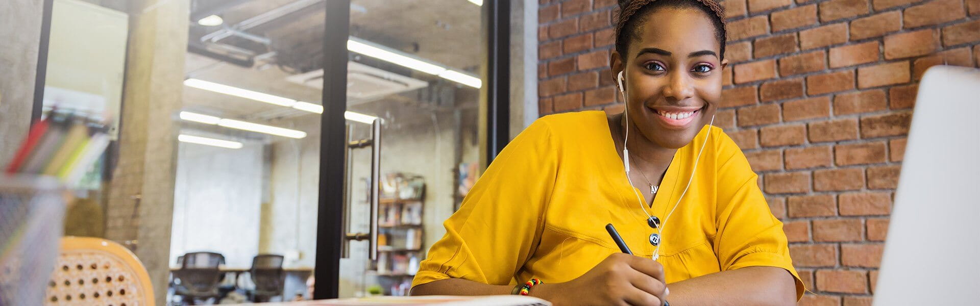 Student appearing to be studying at desk with pen in hand.